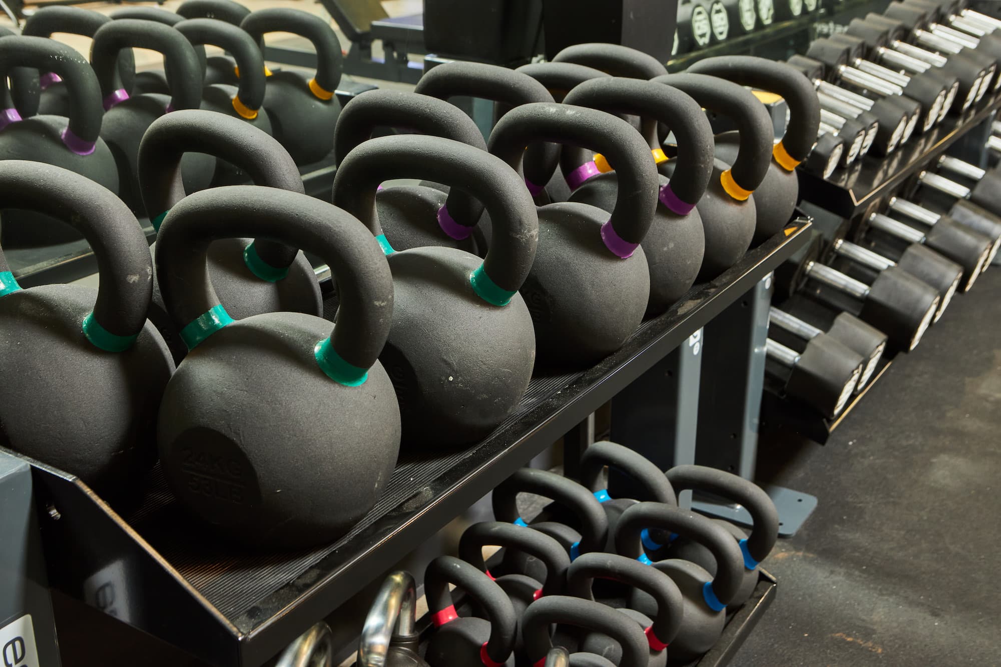 Kettlebells and dumbbells racked in the weight room at Craft Boxing Club Calabasas
