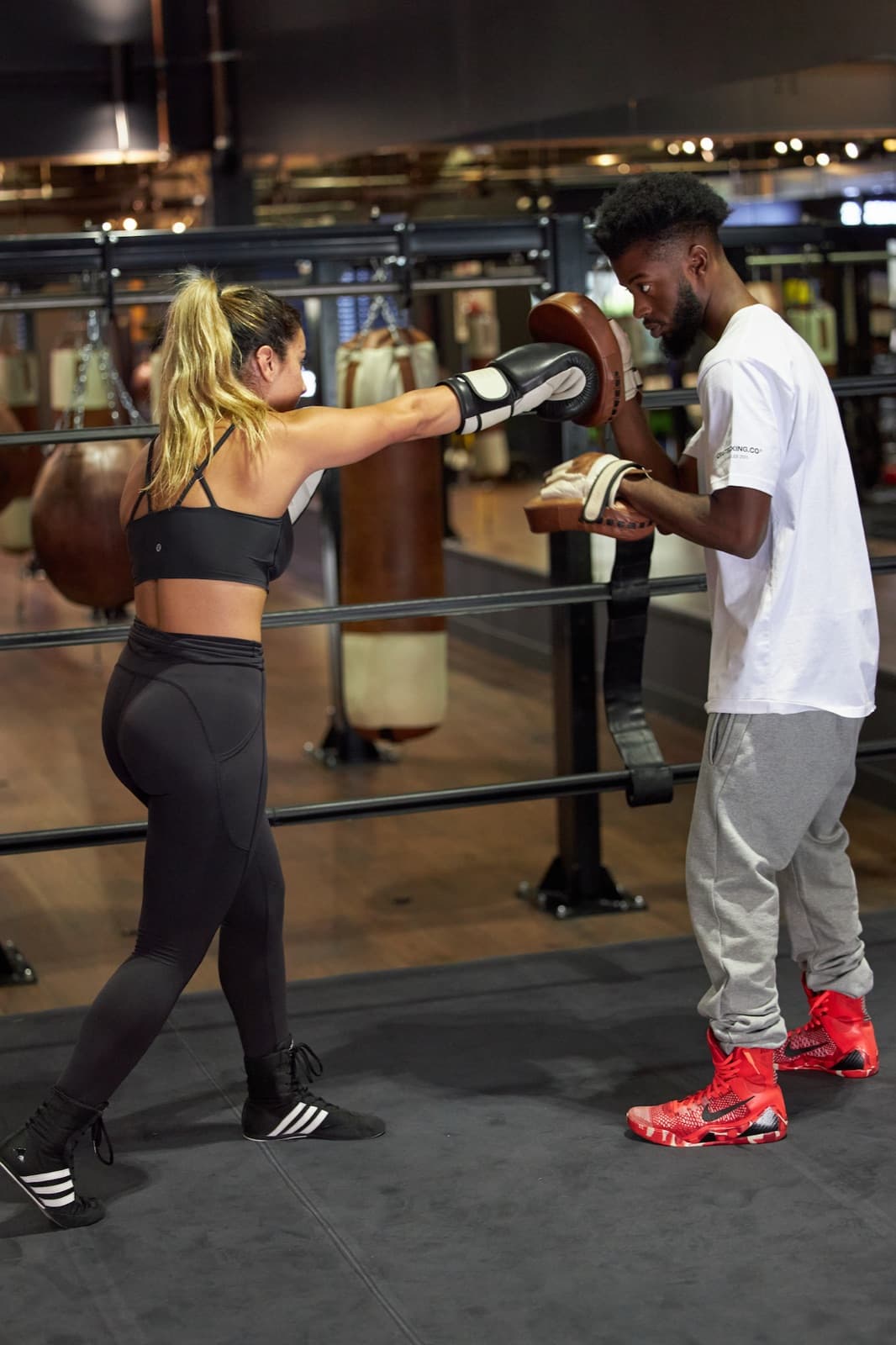 Coach correcting a member's stance